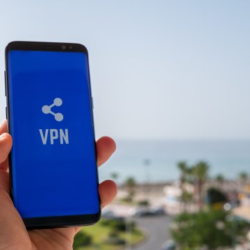 features turbo vpn smartphones mobile devices hand holding smartphone blue screen and vpn exterior beach 